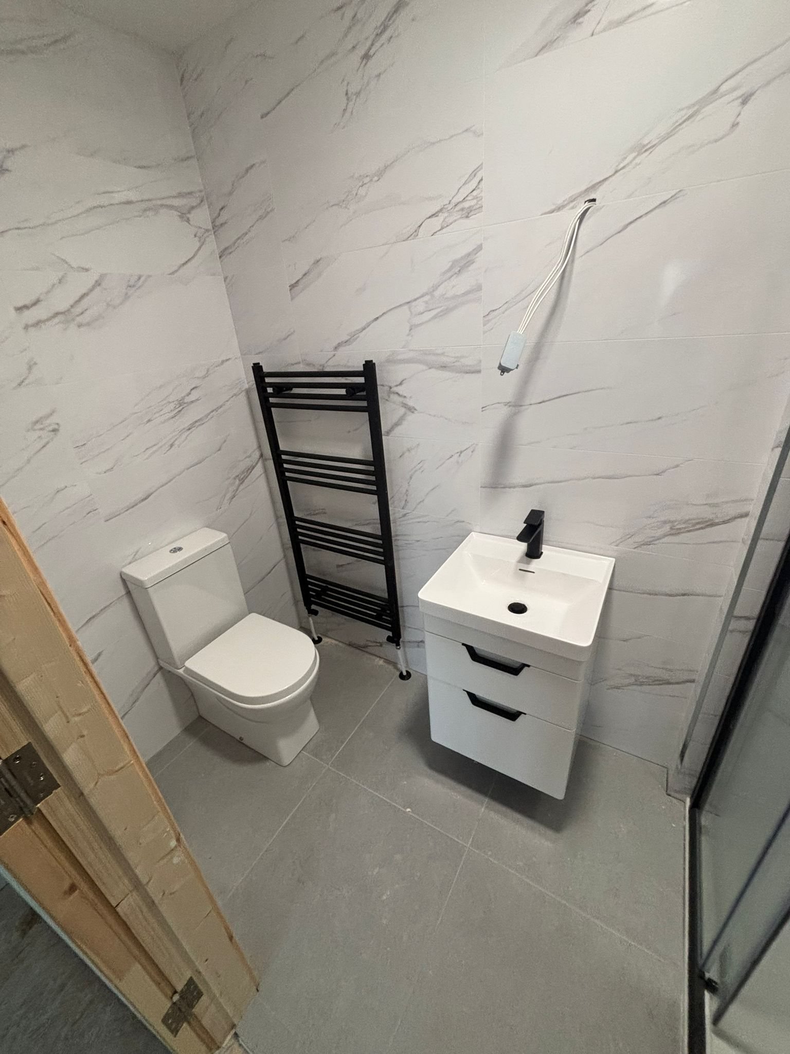 Modern bathroom renovation in Douglas, Cork with large-format tiling